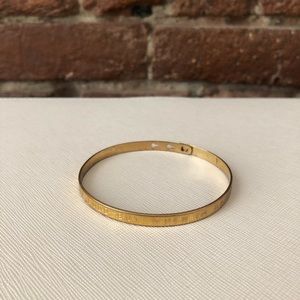 Gold bangle with quote from Paris